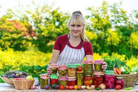 Premium Photo Woman With Jar Preserved Vegetables For Winter