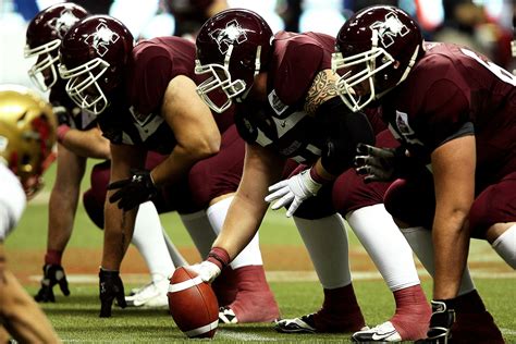 Man Wearing Green American Football Jersey Holding the Ball While ...