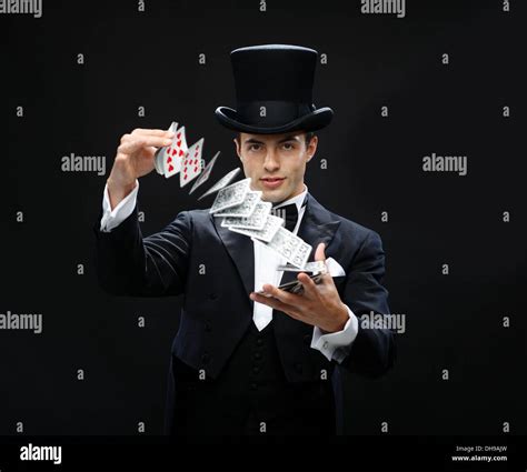 magician showing trick with playing cards Stock Photo - Alamy