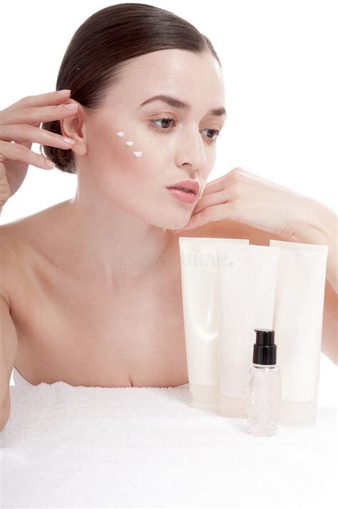 Sensual Woman Applying Cosmetic Cream Treatment On Her Face Stock