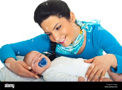 Happy Mother Touching Her Newborn Baby Head And Looking With Admiration