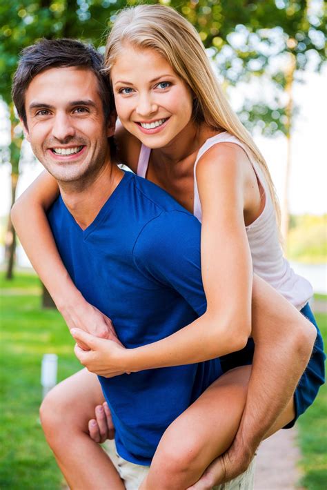 Having Fun Together Low Angle View Of Beautiful Young Loving Couple Standing Outdoors Together