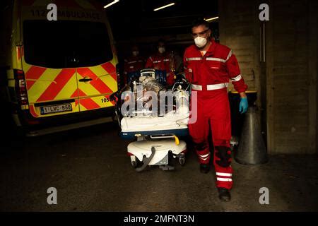 Medical Personnel Wheel A Bed With A Coronavirus Patient As They