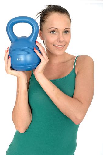 Attractive Healthy Young Woman Lifting A 5kg Kettle Bell Weight Stock