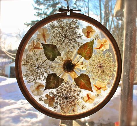 An Embroidery Project With Leaves And Snow In The Background