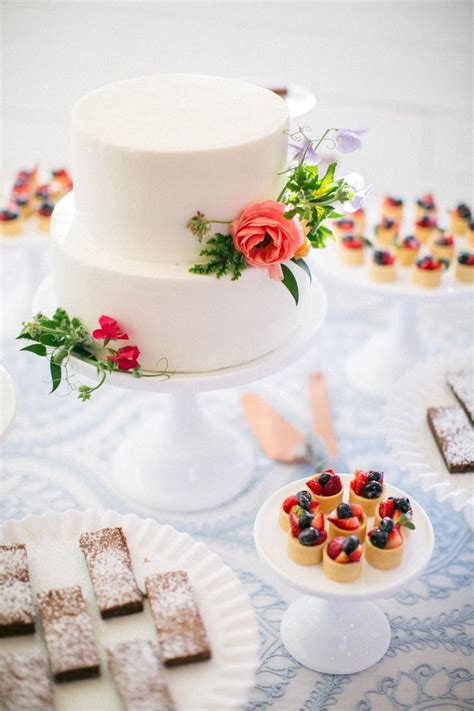 A Table Topped With Cakes And Desserts Covered In Frosting