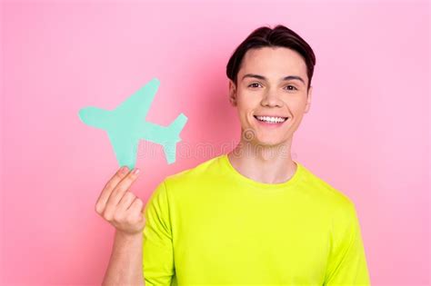 Photo Of Cheerful Positive Guy Wear Green T Shirt Rising Plane Card Isolated Pink Color