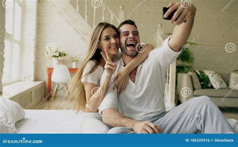 Young Beautiful And Loving Couple Take Selfie Picture On Smartphone