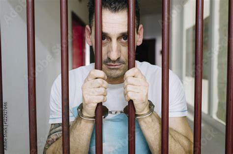 Caucasian Prisoner Behind Bars In Jail Criminal Justice Syste Stock