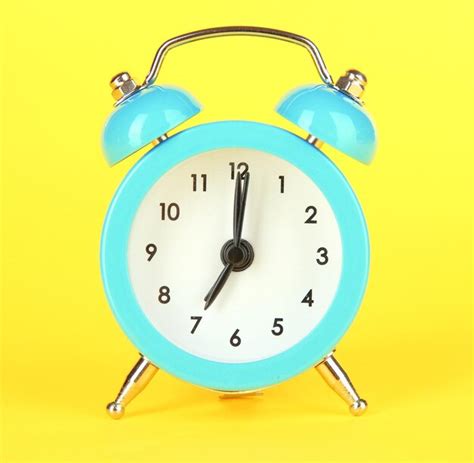 Premium Photo Blue Alarm Clock On Yellow Background