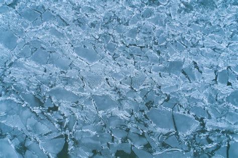 Aerial Top Down View Of Cracked Broken And Melting Ice On A Water