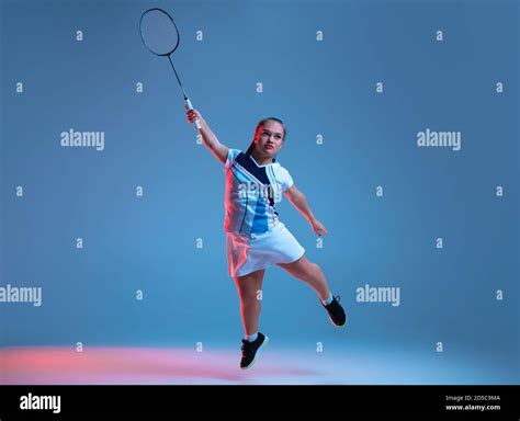 Strong Beautiful Dwarf Woman Practicing In Badminton Isolated On Blue