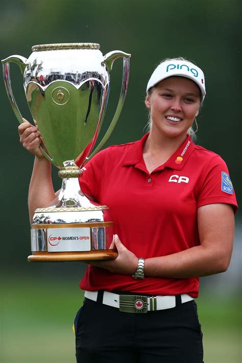 Brooke Henderson of Canada lifts the champions trophy following the ...