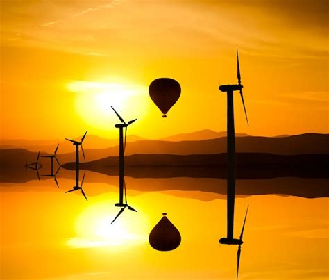Premium Photo Silhouette Of Wind Turbines And A Hot Air Balloon On