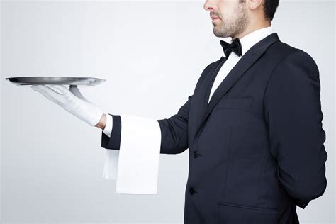 Professional Waiter Holding An Empty Silver Tray Over Gray Backg