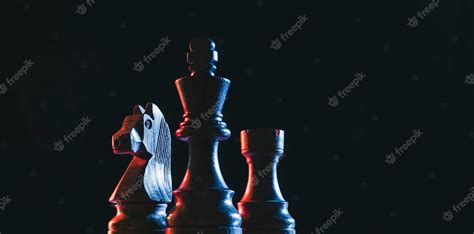 Premium Photo | Chess pieces on a dark background