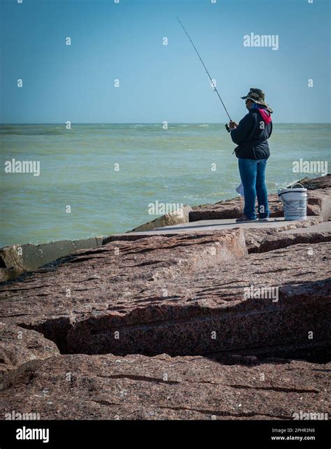 Port Aransas Tx 7 Feb 2023 Woman In Hat Fishing At The South Jetty