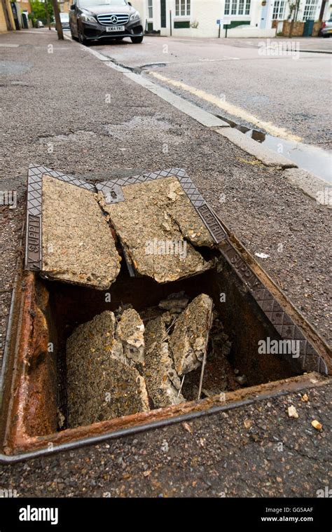 Dangerous Hole In The Pavement Sidewalk Where A Manhole Cover Has