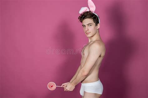 Funny Naked Guy Wearing Bunny Ears Holding Lollipop Over Pink Background Stock Image Image Of