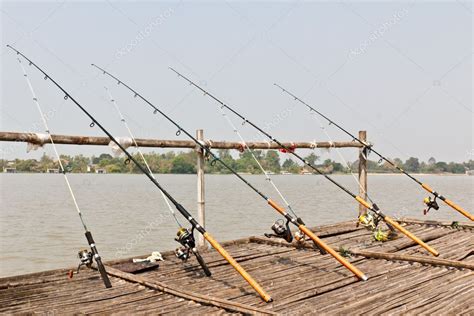 Fishing Poles On Pier — Stock Photo © Stoonn 6491119