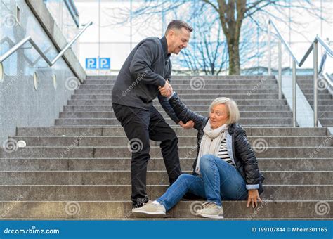 Man Helping Woman To Get Up Stock Photo - Image of stairway, injury: 199107844