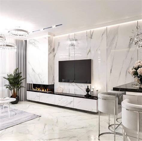 An Elegant Living Room With White Furniture And Marble Walls Along