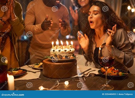 Woman Blowing Out Candles On Birthday Cake Stock Image Image Of