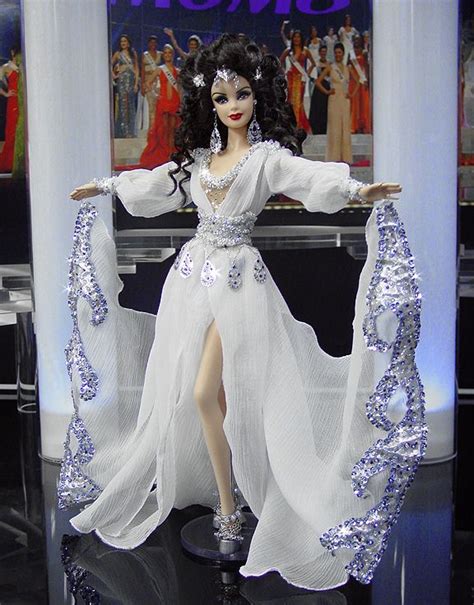 A Barbie Doll Dressed In White And Silver