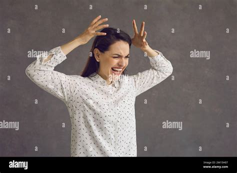 Studio Shot Of An Angry Stressed Young Woman Irritated By Work And Life