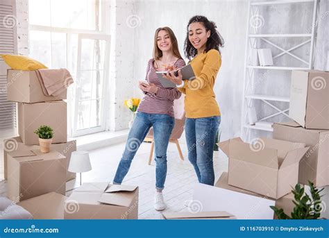 cheerful pretty girl checking list  belongings stock photo image