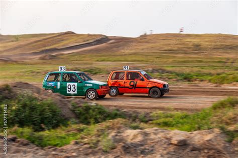 Rally off-road car make a turn with the clouds and splashes of sand ...