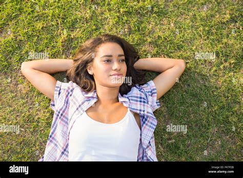 Pretty Brunette Relaxing In The Grass Stock Photo Alamy