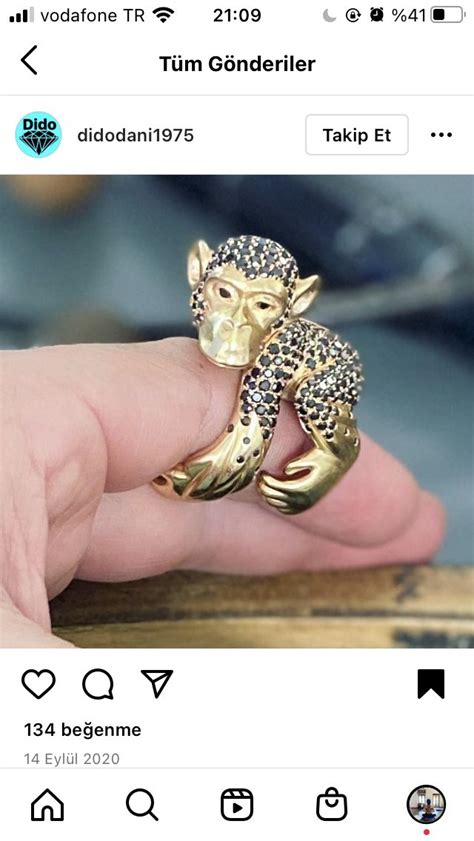 Someone Is Holding A Gold Monkey Ring With Diamonds On Its Head And It