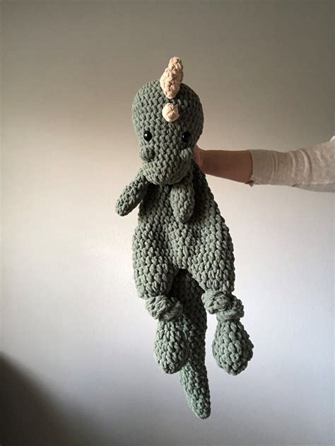 This Super Soft Plush And Thick Hand Crocheted Dinosaur Snuggler Will