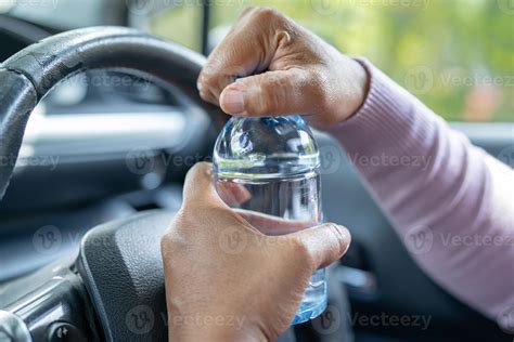 Asian Woman Driver Holding Bottle For Drink Water While Driving A Car Plastic Hot Water Bottle