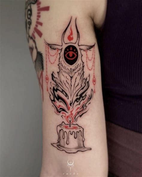 A Woman S Arm With A Black And Red Tattoo Design On The Left Side Of