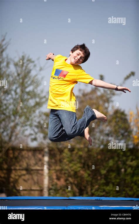 Leaping Boy On Trampoline Stock Photo Alamy