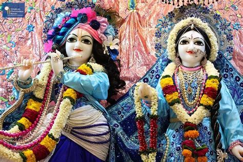 Two Statues Of Hindu Deities Dressed In Colorful Clothing