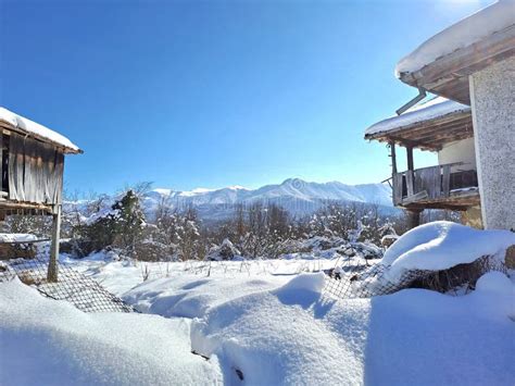 Snowy Scene with Old Barns and Mountains Stock Image - Image of house ...