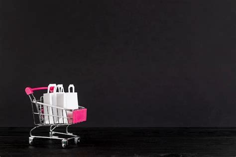 Shopping Cart On Black Background With Copy Space Free Photo