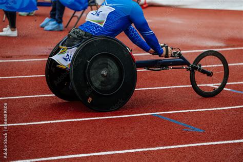 male athlete in wheelchair racing competition at stadium Stock Photo ...