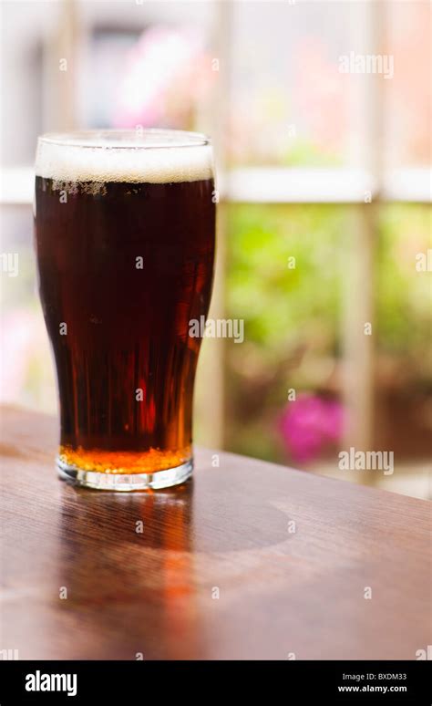 Glass of Irish ale in pub Stock Photo - Alamy
