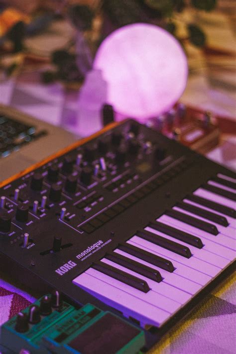 A Korg Monologue Synthesizer Beside A Green Device · Free Stock Photo