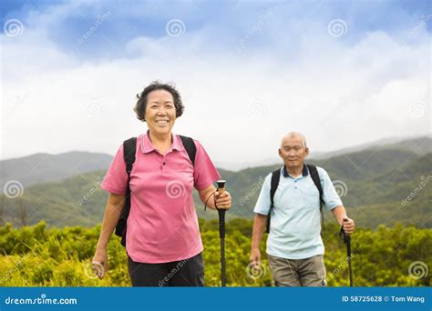 Happy Senior Couple Hiking On The Mountain Stock Photo Image Of