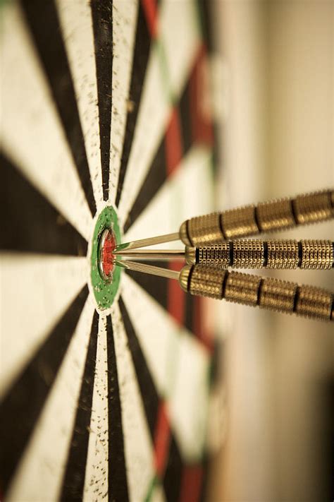 Darts In Bull's-eye Of Target by Thinkstock