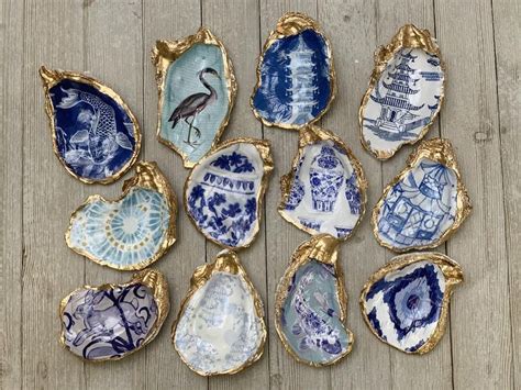 Twelve Blue And White Porcelain Seashells With Gold Rimmed Lids On