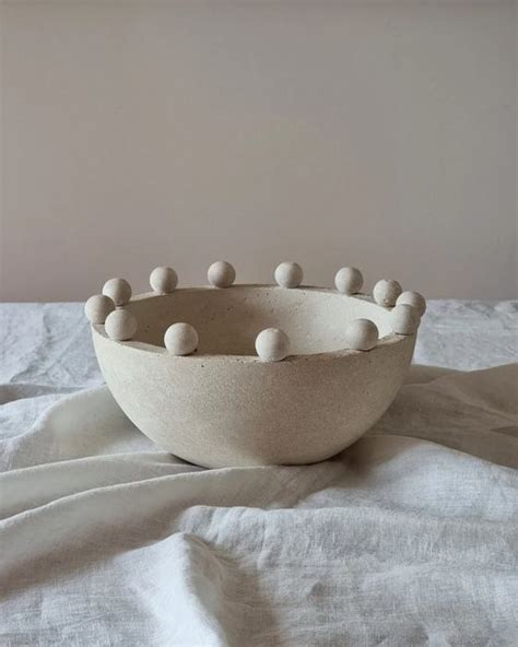 A Bowl With Balls In It Sitting On A Bed