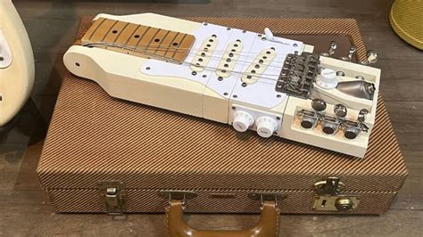 foldable electric guitar for travel fits inside briefcase that has ...