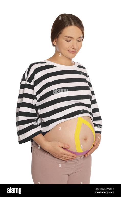 Pregnant Woman With Kinesio Tapes On Her Belly Against White Background