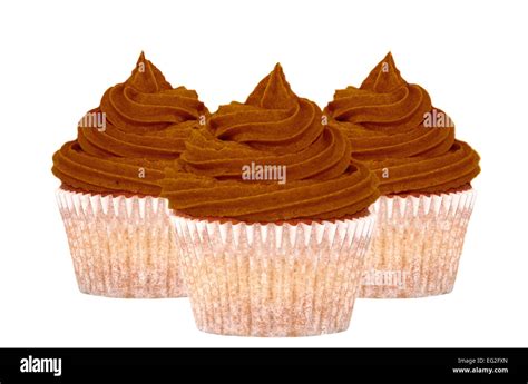 Three Chocolate Cupcakes With Swirls Of Icing Isolated On A White